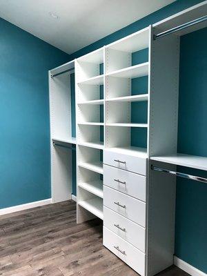 Standard white closet. The blue walls really show the clean lines.