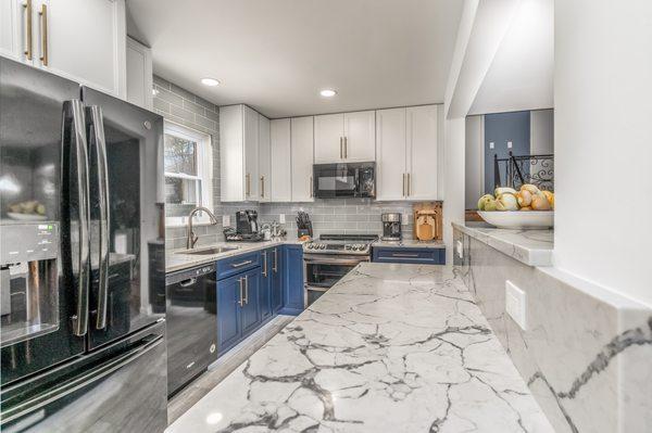 Kitchen remodel with blue cabinets,grey countertop,wooden flooring,Silver Spring