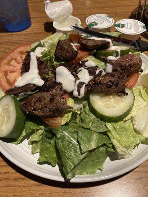 Hunt Club Salad with steak and salad dressing containers in back