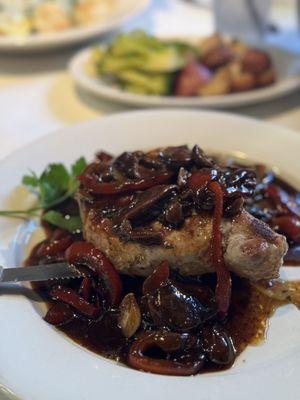 pork chop with mushrooms and vinegar peppers.