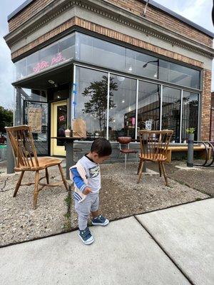 My son enjoying the outdoor sitting area while eating his strawberry scone.