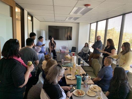 The Fedelta Home Care team gathers around the table enjoying a potluck