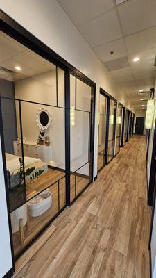 Our beautiful hallway, lined with custom sliding glass doors on one side and crystal wall sconces and gorgeous black wood doors on the other