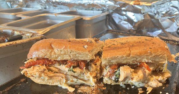 The Salvatore  Grilled chicken, fresh, basil, sun-dried, tomato, EVOO, Italian seasoning and provolone.