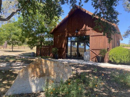 Love this view of the tasting room and the signature sign  for "Shadow Run" with California poppies!