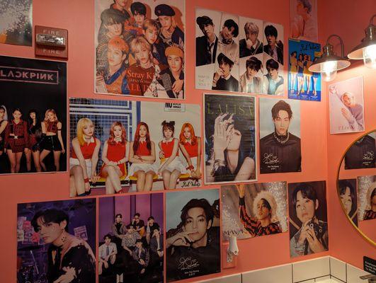 Lots of Kpop posters in the bathroom