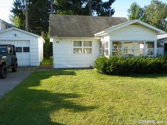 This home is set back on the lot and has a big front yard! Greece schools, glassed in front porch and 2 bedrooms...