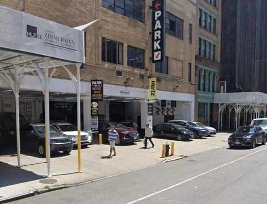 Cars illegally parked on the pedestrian sidewalk.