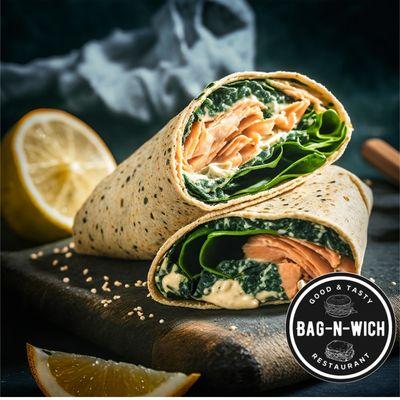 Savor our Greek Wrap: smoked salmon, fresh spinach, and creamy sauce in a herb wrap. Fresh, flavorful, and light!