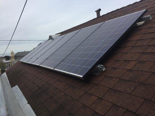 Six solar panels, rack mounted, south side of roof