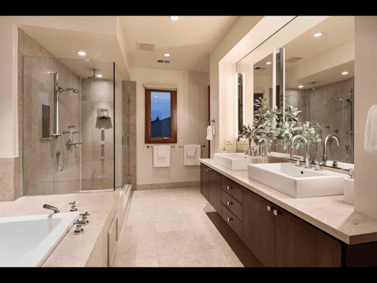 Fremont bathroom with walk-in shower, soaking tub, and dual vanity, featuring marble tile and chrome fixtures.