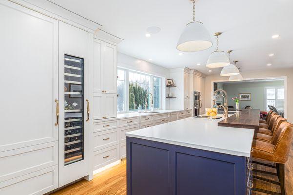 A kitchen that features the classic color palette of blue and white cabinetry.