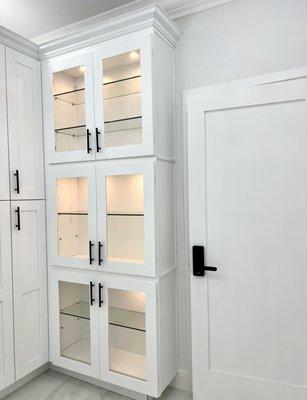 Custom built wall in closet space with glass doors that are perfect to show case handbags, perfume collections, or antiques.