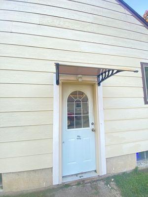 New awning and light fixture after color matching paint on the siding