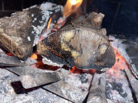 Bubbling wood bc of all the moisture after the last few have cracked, hissed &  popped