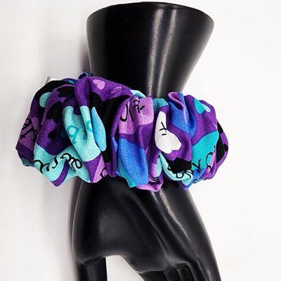 "Elevate your hair game with our 'Heartfelt Healing' Scrunchie. This unique scrunchie blends shades of purple and blue, adorned with charmin