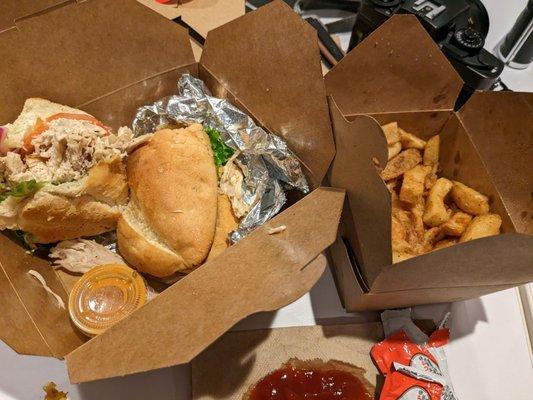 Chicken sandwich and a side of french fries.