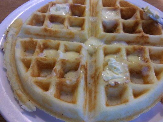 Plain waffle before being drenched with pecan syrup.