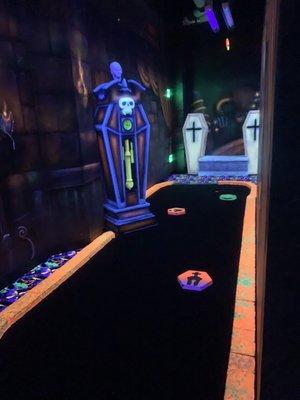 Black light mini golf..this one had a clock that would go off when your ball hit the bottom