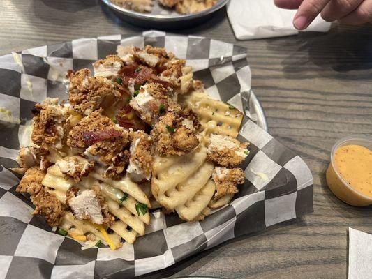 Loaded clucker fries smothered in white queso