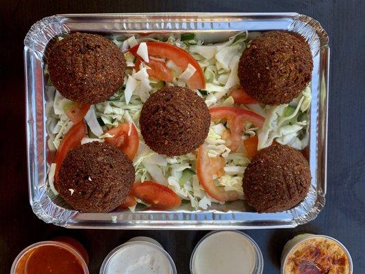 We have vegetarian options! Here is our falafel salad. Served on a bed of lettuce with tomato, cucumbers, and your choice of sauces.