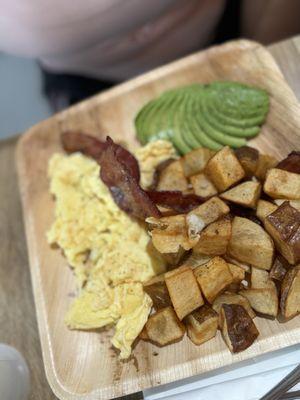 Eggs Your Way, with potatoes and bacon with a side of avocado