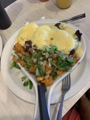 Steak Tip Benedict with peppers and onions over homefries