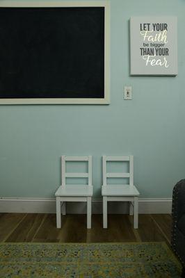 A chalk board and small chairs for your little bundle of joy