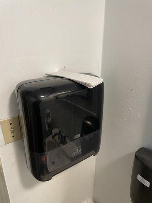 Dispenser not working, paper towels just laid on top.