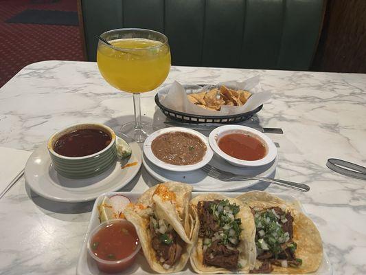 Birria tacos,, chips, beans & salsa, mango margarita.