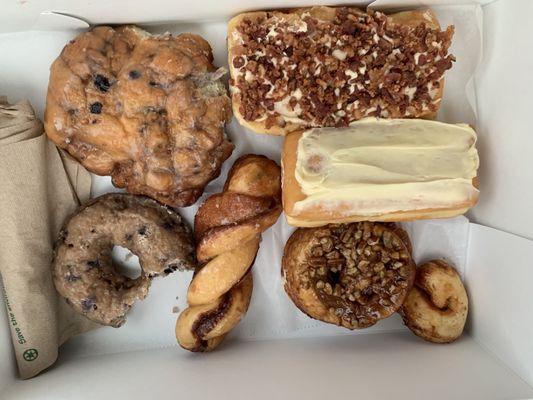 Blueberry Fritter, blueberry cake donut, donut twist, maple bacon, strawberry cheesecake, and sticky bun!