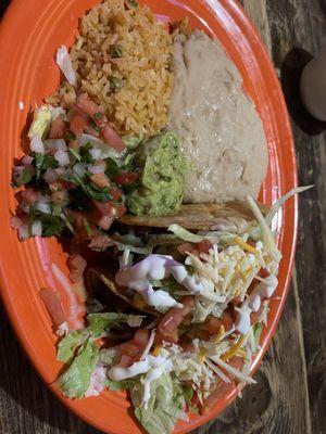 Two beef tacos with beans and rice