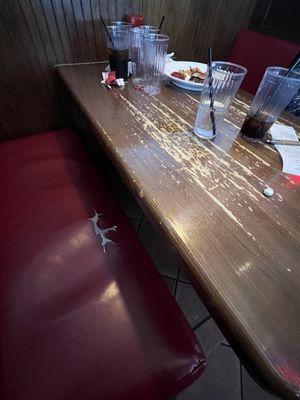 Ripped booth, scratched table