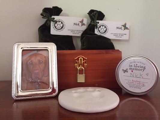 The box with Nick's ashes, the two pouches with the extra ashes, the paw print and the candle. I added his photo in a frame.