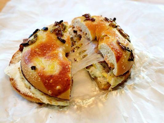 The Firebird - Sausage, Bacon, Egg, Swiss, Cream Cheese and hot sauce on a Jalapeno Cheddar Bagel