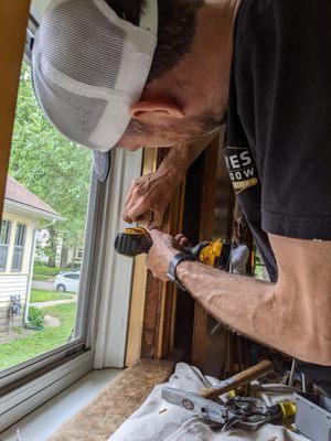 Installing spring bronze weatherstripping in a double-hung window for a home in Minneapolis, Minnesota.