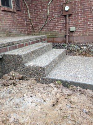 Exposed aggregate with brick inlay.  Brick matches rest of home.