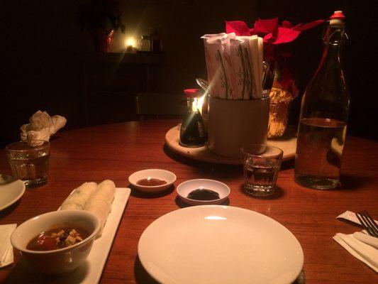 Table with appetizer (spring rolls with peanut sauce)