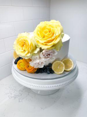 Lemon Cake with blueberry filling and white buttercream. (Flowers and decorated by florist)