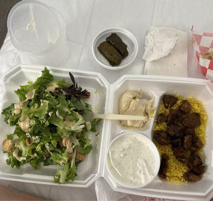 Lamb platter with Cesar salad and hummus. Added side of tzatziki sauce and two stuffed grape leaves.