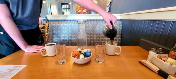 Waiter pouring coffee