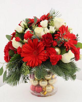 Gold Coast Christmas-Red roses, gerberas, white spray roses, and  white mini carnations are exquisitely arranged with white asiatic lilies