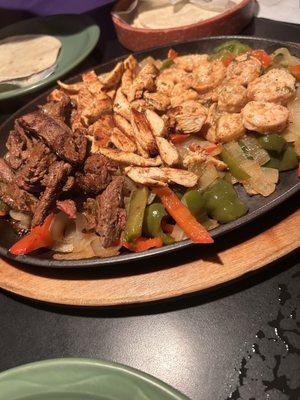 Steak shrimp and chicken fajitas