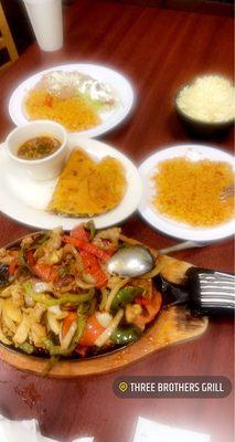 Chicken Fajitas Plate with extra Rice and shredded cheese.