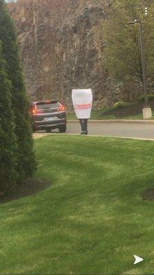 Dunkin Donuts Coffee Cup walking through the drive through saying hello. Great way to start a day. With a smile and a coffee.