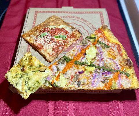 Spinach-artichoke bombini, Grandma Bess square and V For Vegan slice.