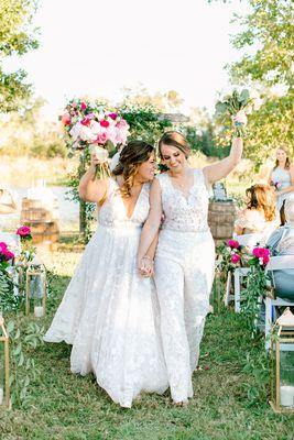 The brides in the outdoor ceremony aisle.