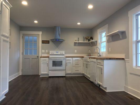 Full Kitchen renovation, all new electrical, plumbing, flooring, lighting, butcher block counter top with farm house sink.