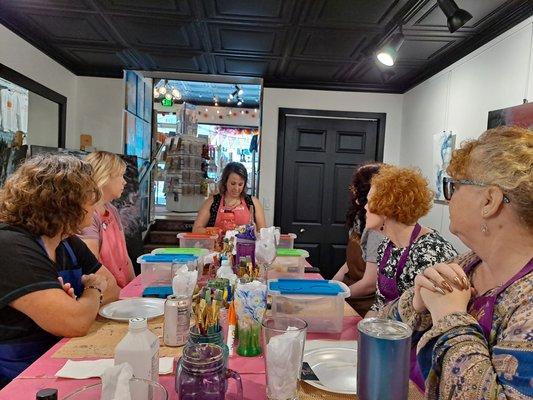 Lauren, Colors and Cocktails owner, teaching guests about glass painting