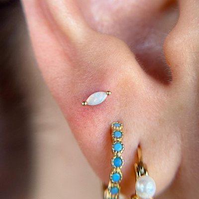 Fresh third lobe with Buddha Jewelry's yellow gold and genuine opal, "Zuri."